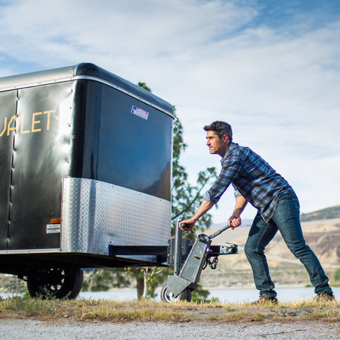 Outdoor setting showing user maneuvering trailer using Trailer Valet 5X - REFTV5X