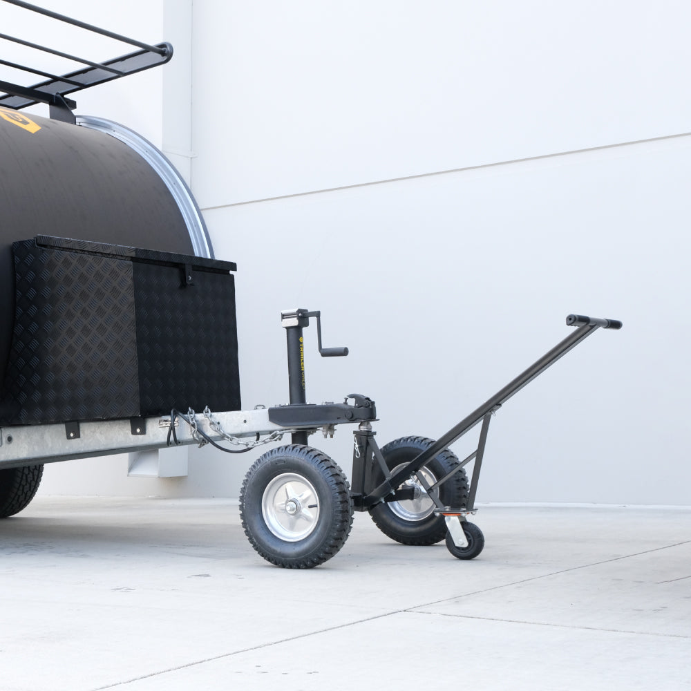 Lifestyle photo of the Trailer Valet Standard Bundle connected to trailer – compact dolly and jack in use - TVEHADB1
